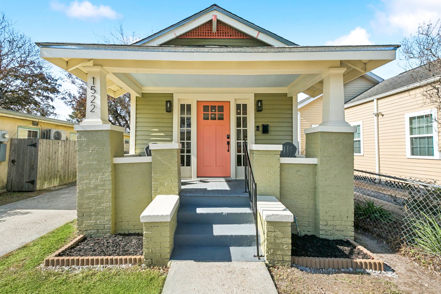 Renovated craftsman-style bungalow exterior with fresh paint and porch columns