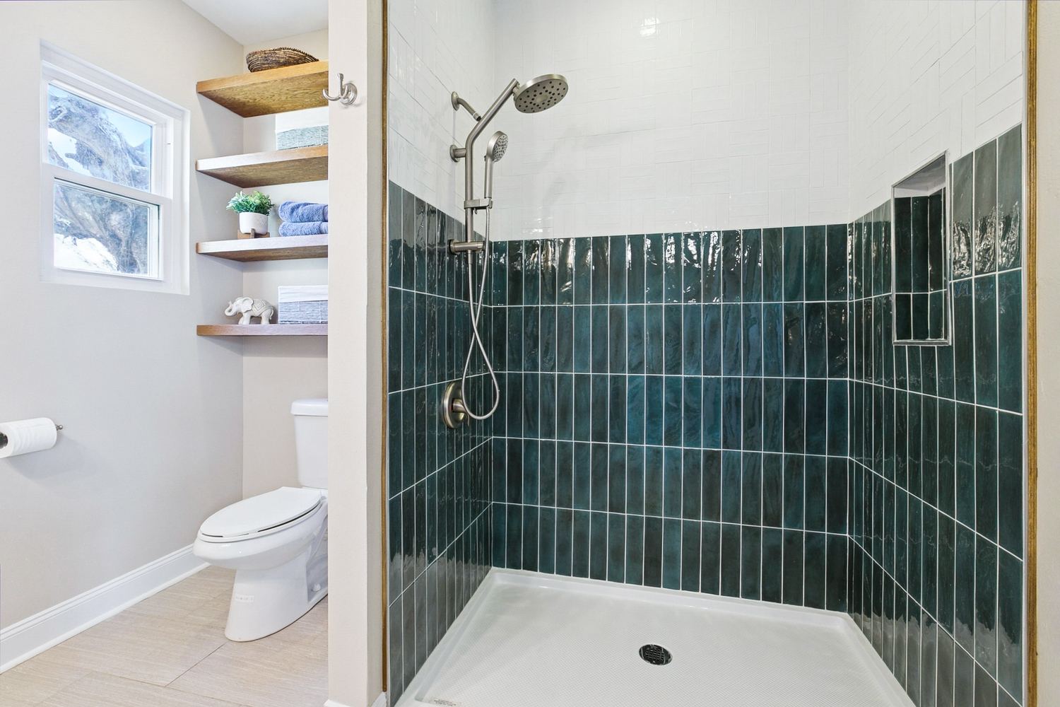 Walk-in shower remodel with hand-glazed tile and built-in niche