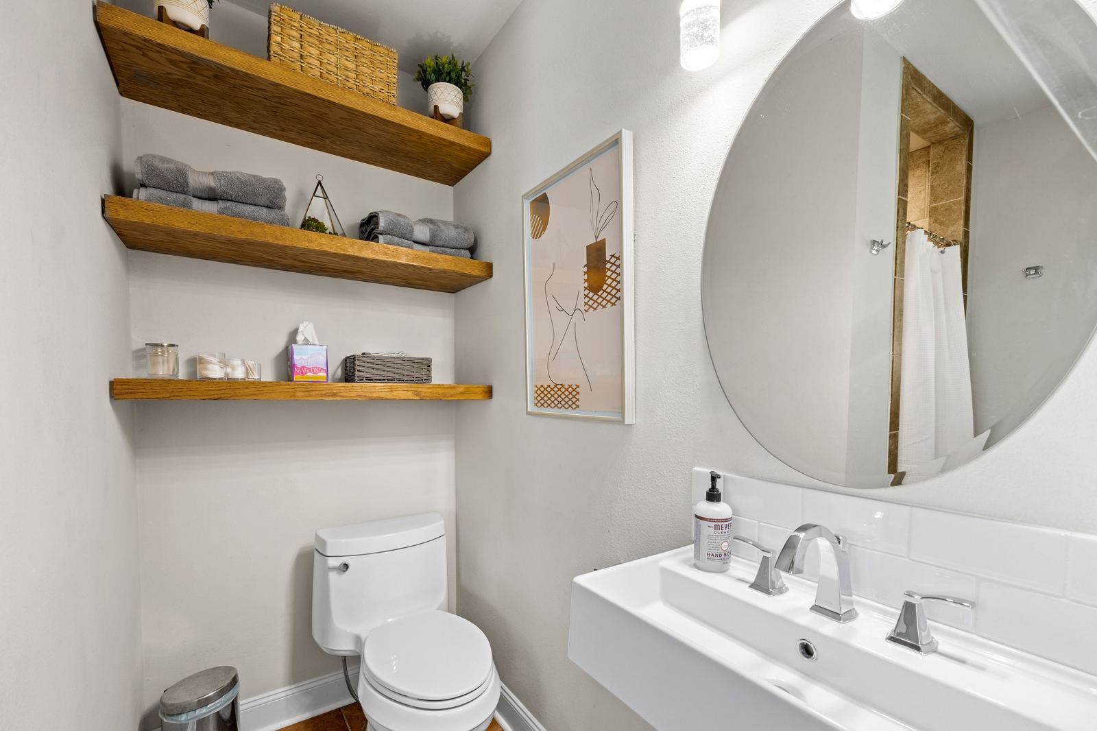 Powder room remodel with floating wood shelving